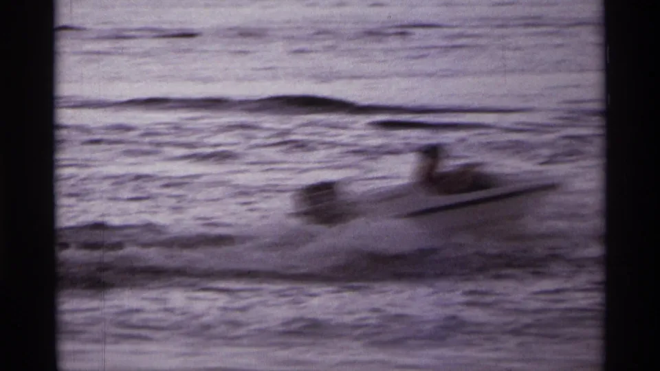 The white speedboat appears blurred by motion as it speeds across choppy water in the Orlando-area 8mm clip.