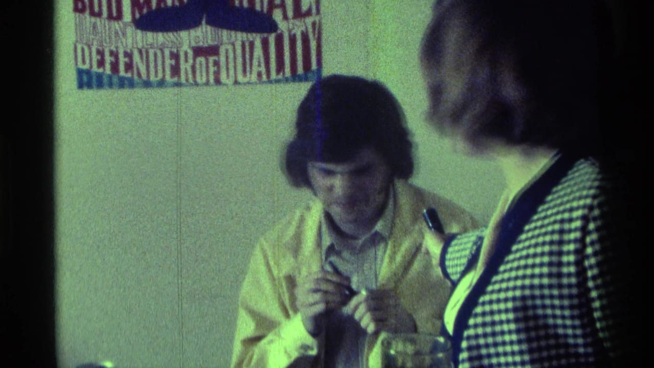 The 1976 Kentucky frame shows the man looking down at his hands as the off-screen interviewer holds a microphone nearby.
