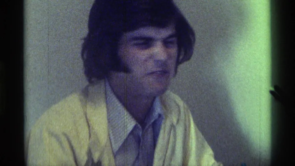1976 Kentucky 8mm frame with the man making an exaggerated facial expression during the informal interview.