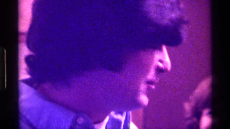 The subject turns into side profile in the final 1976 Kentucky home-movie frame, with strong purple cast and visible Super 8 framing.