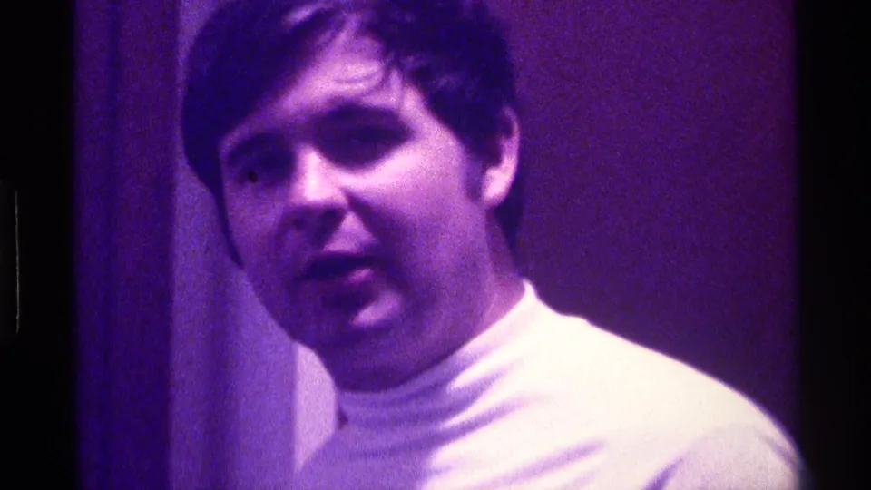 Young man appears to speak toward the camera in purple-tinted 1976 Kentucky home-movie footage.