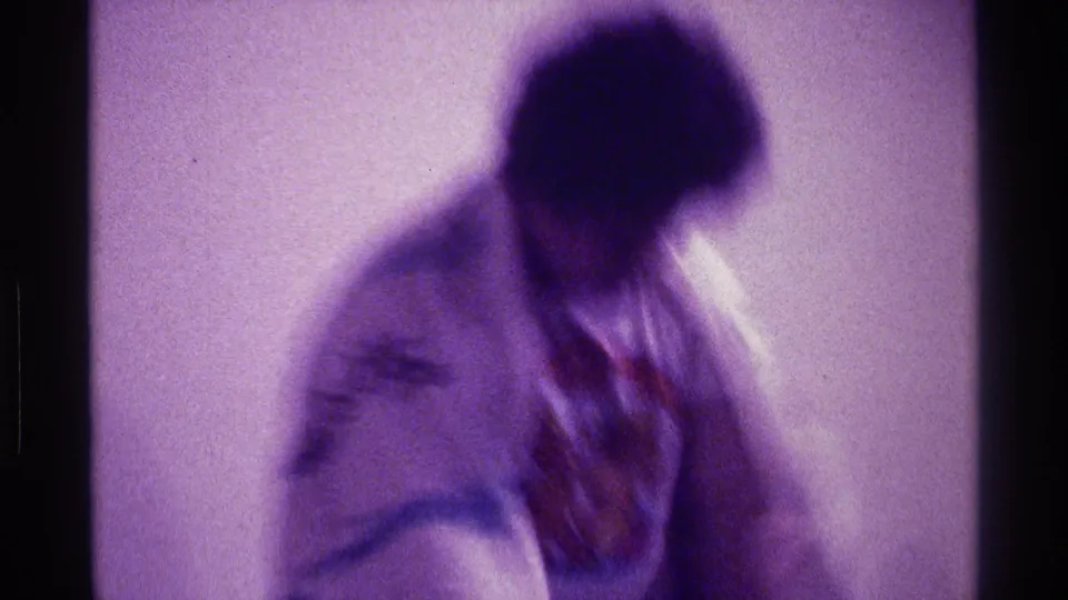 The final frame shows a blurred adult man in a light shirt moving goofily inside a private room, with a draped garment trailing at his side.