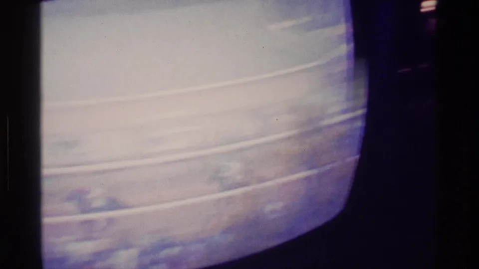 Soft 8mm view of a horse race playing on a rounded television screen in a Kentucky home setting.