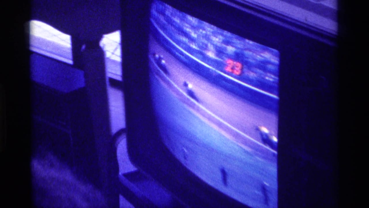 Close view of a television screen showing horses racing on a track.