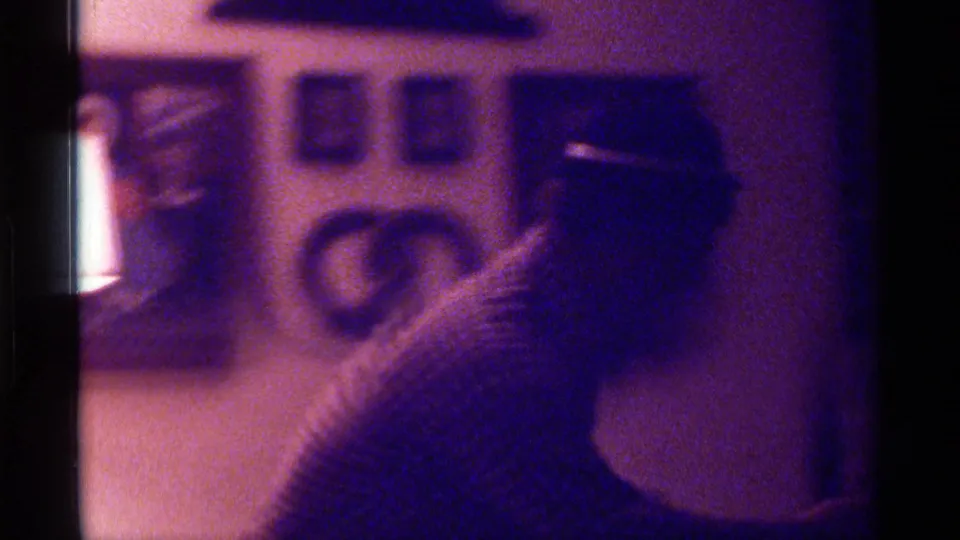At the end of the 1976 Kentucky 8mm clip, the man turns partly out of frame with the microphone lowered or obscured.