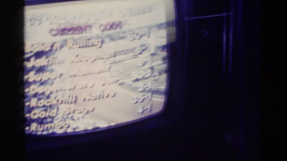A vintage TV fills the frame with horse-racing odds and partially legible names, consistent with the 1976 Kentucky Derby viewing context in the clip metadata.