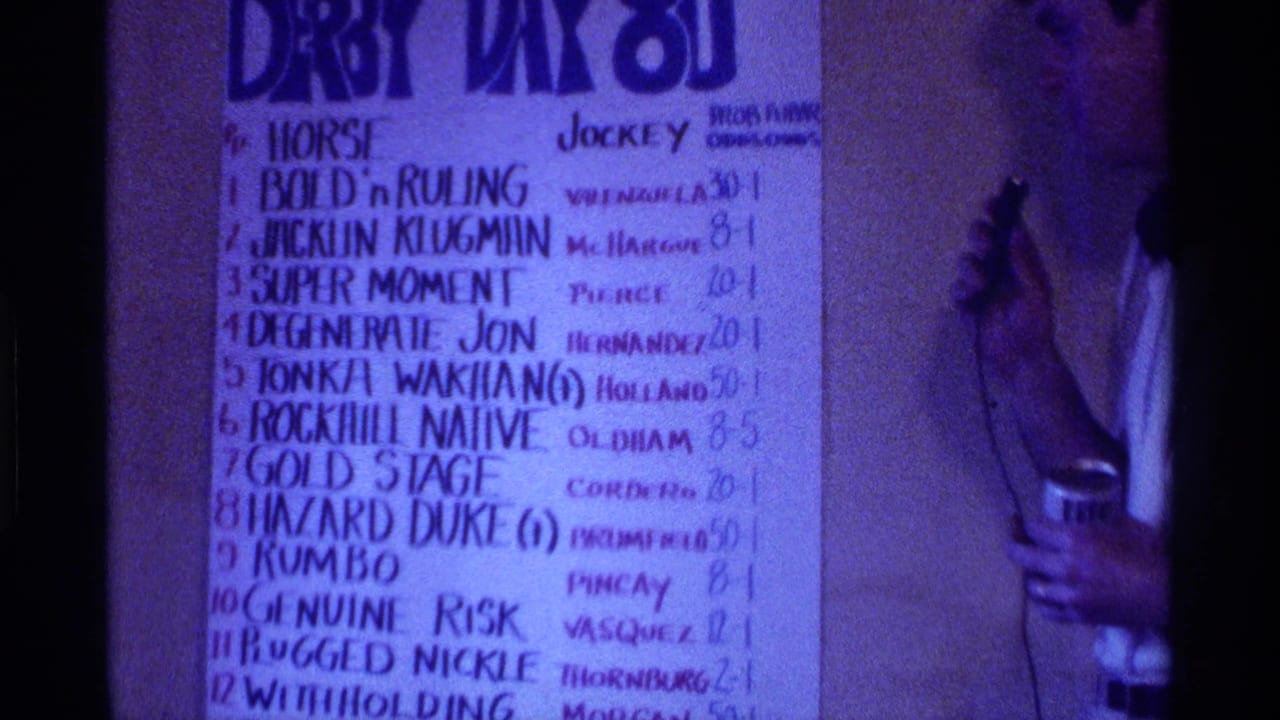 Handwritten horse racing odds chart with a man partly visible at right.