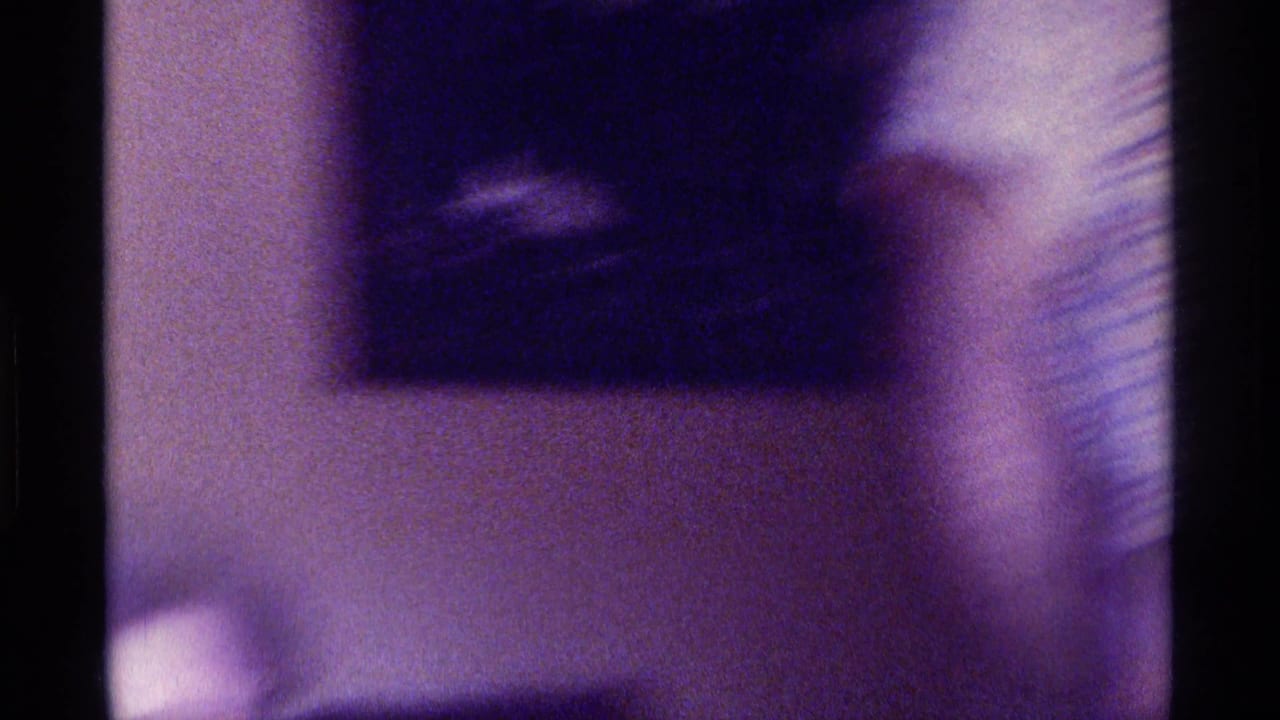 Blurred close interior view with a wall, dark upper shape, and vertical edge.