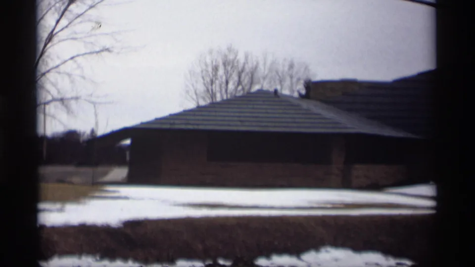1966 Madison view of the building from a slightly different angle, with bare trees, snow patches and winter grass visible.