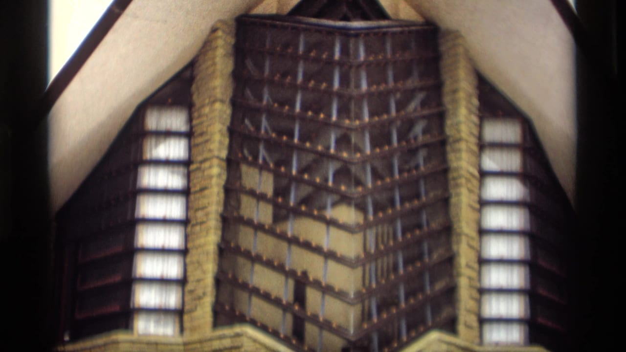 1960s Madison-area 8mm frame showing a close architectural detail with vertical windows, patterned facade, and roofline edges.
