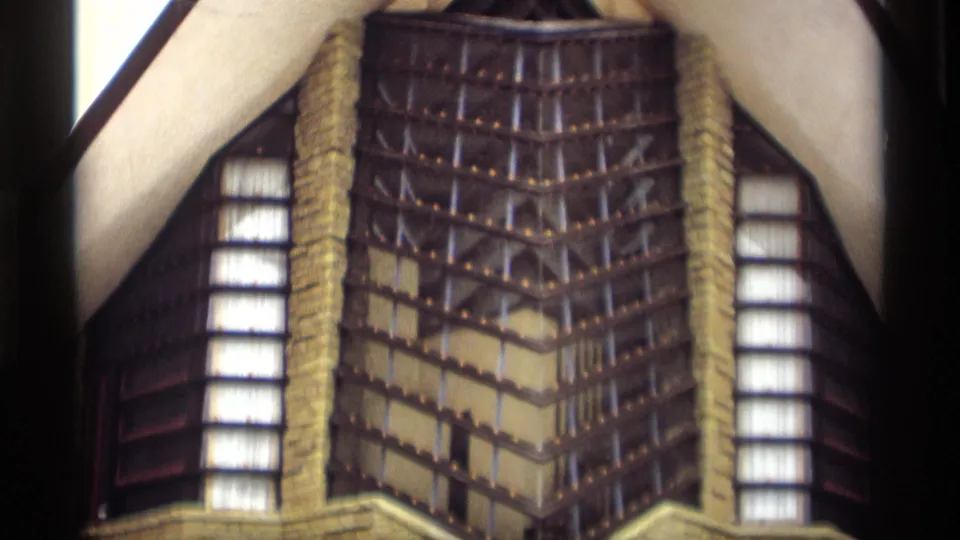 8mm frame of a decorative building facade in Madison footage, with vertical windows, patterned exterior detail, and visible film borders.