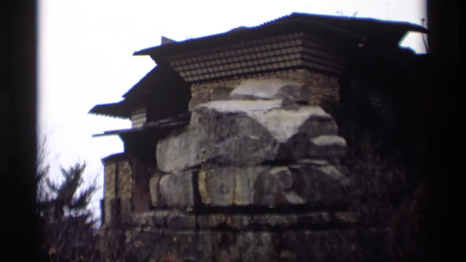 Close view of a rustic stone-and-wood structure, possibly historic, filmed after the Madison street scene.