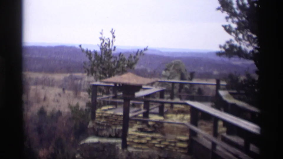 Soft 8mm frame of a wood-and-stone observation area in Madison, Wisconsin, facing a tree-dotted horizon.