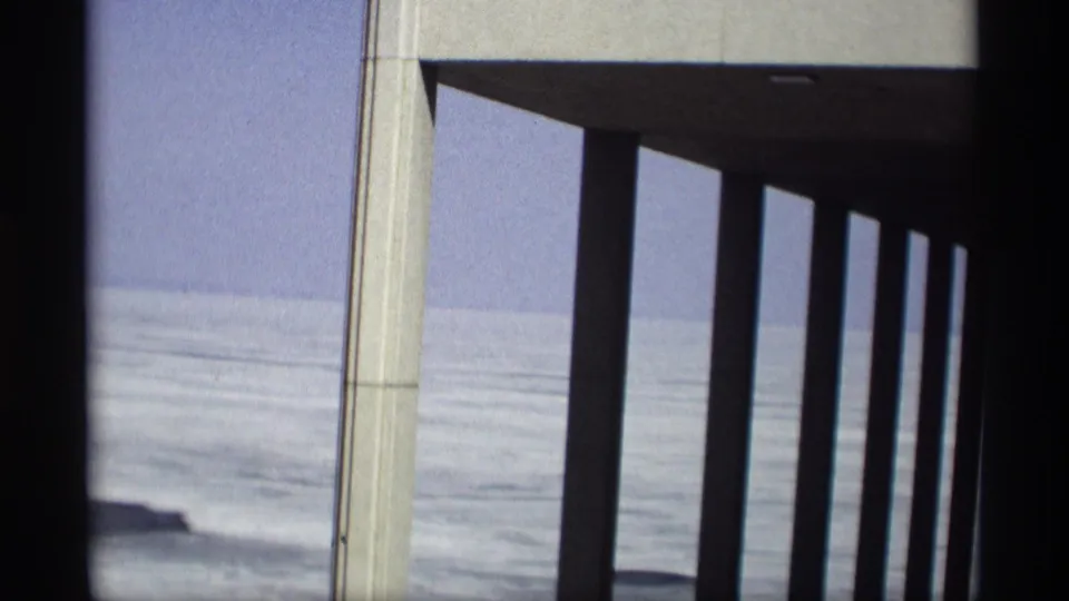 A concrete pier or overhang frames the Madison frozen lake view in this 1966 8mm home-movie still.
