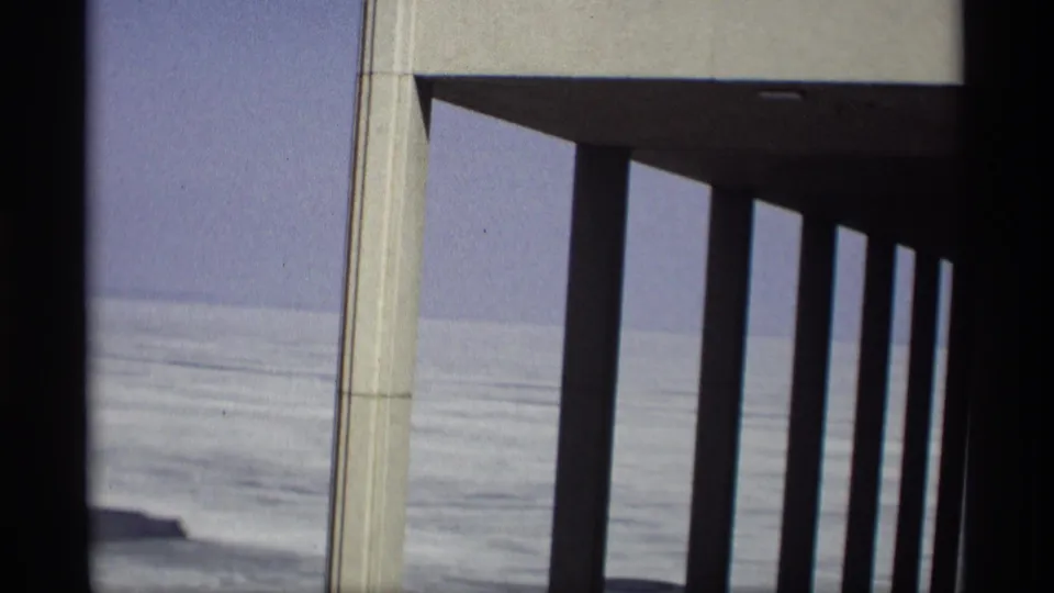 1966 Madison, Wisconsin frame showing a concrete pier structure with lake ice and sky beyond.