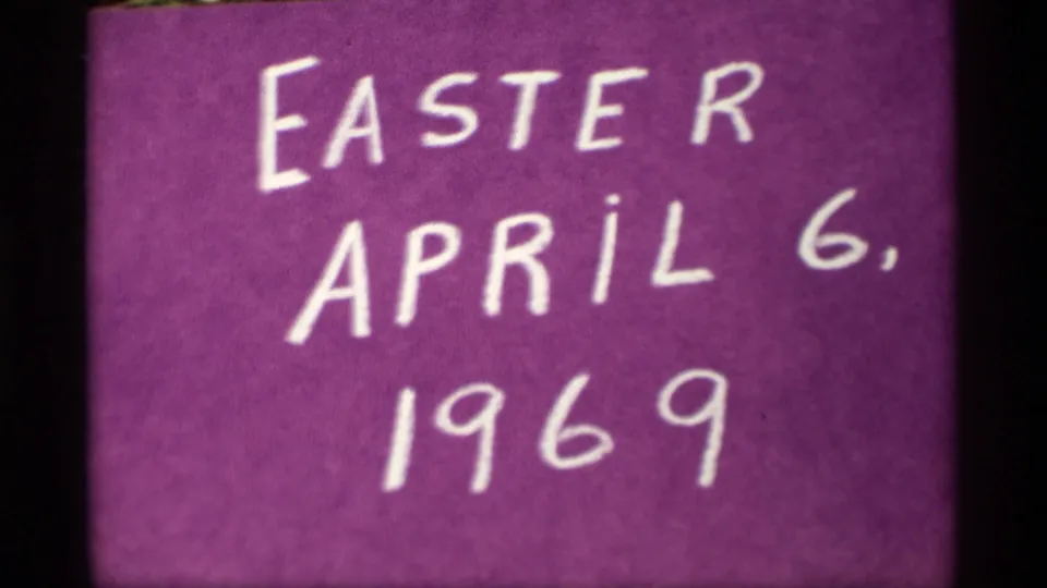Large handwritten Easter title text and 1969 date on a purple card, seen with visible film softness and grain.