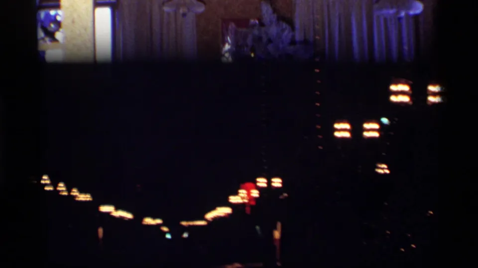 Brief blurry night-light view following the Christmas tree shot in 1968 Chicago home-movie footage.