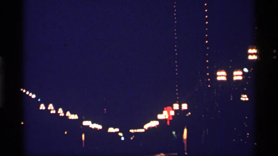 Night driving view in Chicago, 1968, with blurred lights receding across the frame.