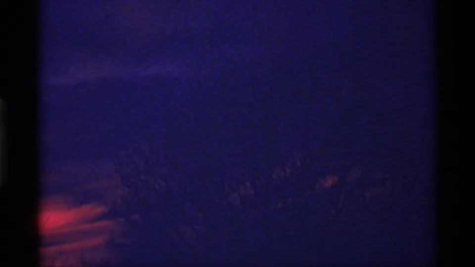 Late clip frame with subdued blue-purple sky, faint red sunset cloud bands, and barely visible brush silhouettes from the 1968 Chicago-attributed film.
