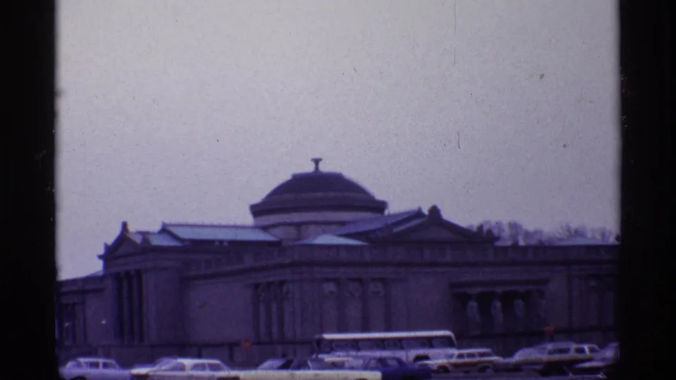 Chicago street view from 1968 with a domed classical facade, parked automobiles, and a white bus in front.
