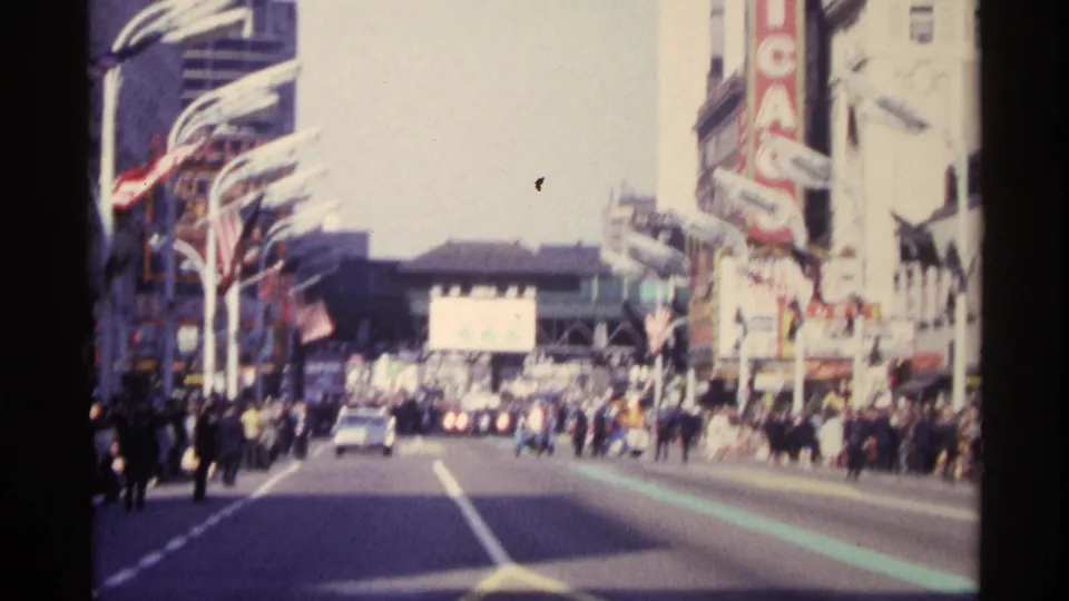 1968 Chicago street view looking toward traffic and pedestrians near the vertical Chicago Theatre marquee.