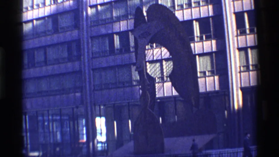 Chicago 1968 street view of an abstract sculpture and gridded high-rise facade, with small pedestrians visible near the base.