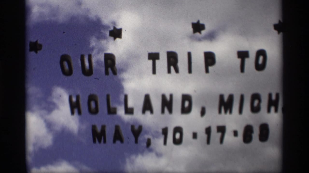 Homemade title card reading Our Trip to Holland, Mich. May 10-17-69 over cloudy sky.