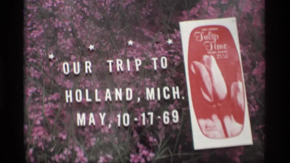 Close view of the 1969 Holland, Michigan trip title with Tulip Time program, shot on 8mm home-movie film.