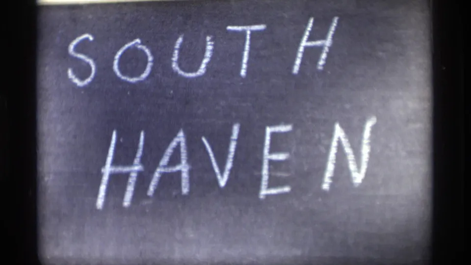 Close-up of a chalkboard sign reading SOUTH HAVEN in white chalk, filling most of the 8mm frame.