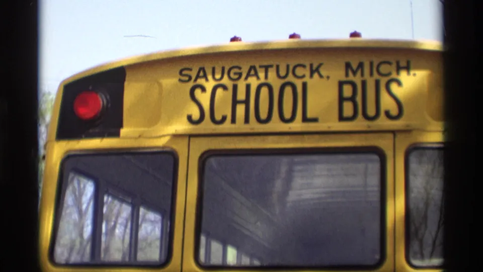 Rear of a Saugatuck, Mich. school bus in 1969 home-movie footage, with destination lettering clearly visible.