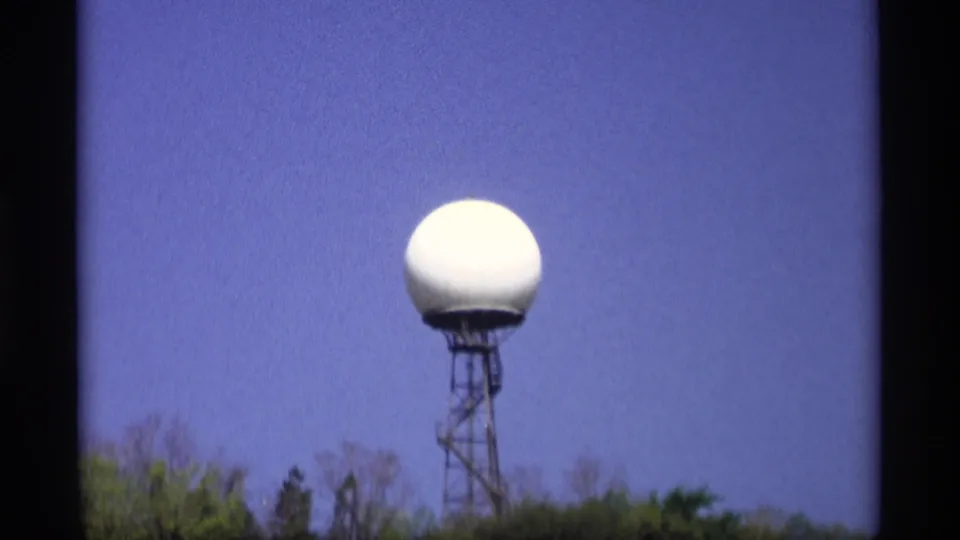 White radar-like dome on a metal tower near Holland, Michigan, filmed in 1969 home-movie footage.