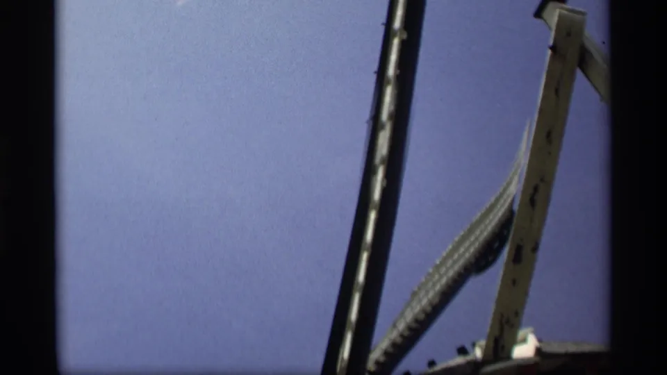 End frame of the 1969 Holland, Michigan windmill view, with rotating blades, a wooden upright, and blue sky in 8mm color.