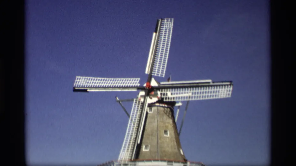 1969 Holland, Michigan frame of the windmill with its sails shifted in rotation, filmed from a low visitor perspective.