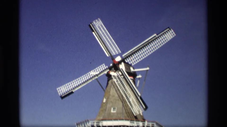 1969 Holland, Michigan 8mm still showing the windmill blades at a new angle, with the tower roofline entering the lower frame.