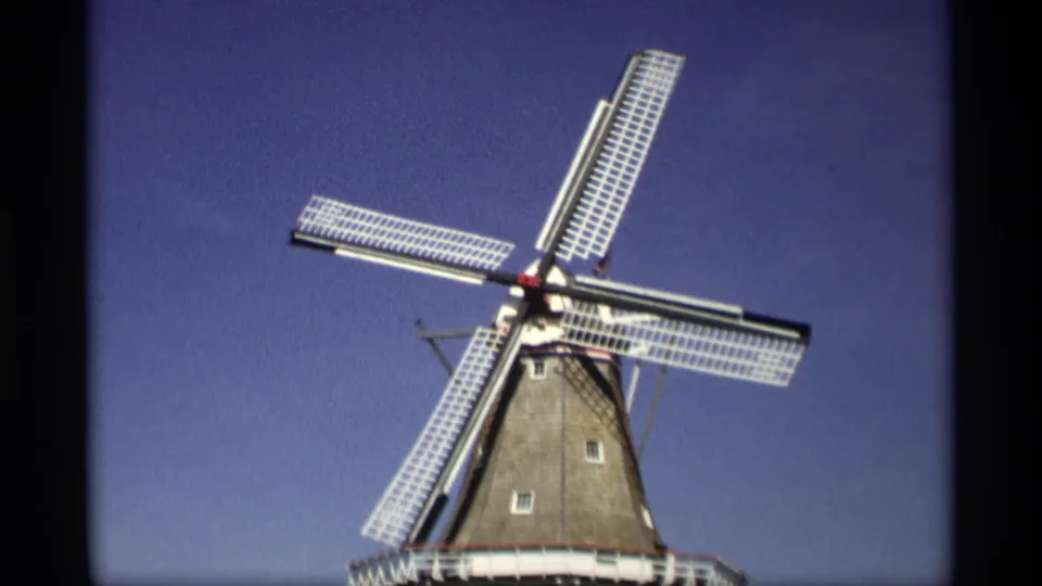 Final 1969 Holland, Michigan frame with the Dutch-style windmill blades diagonally positioned over the tower in bright daylight.