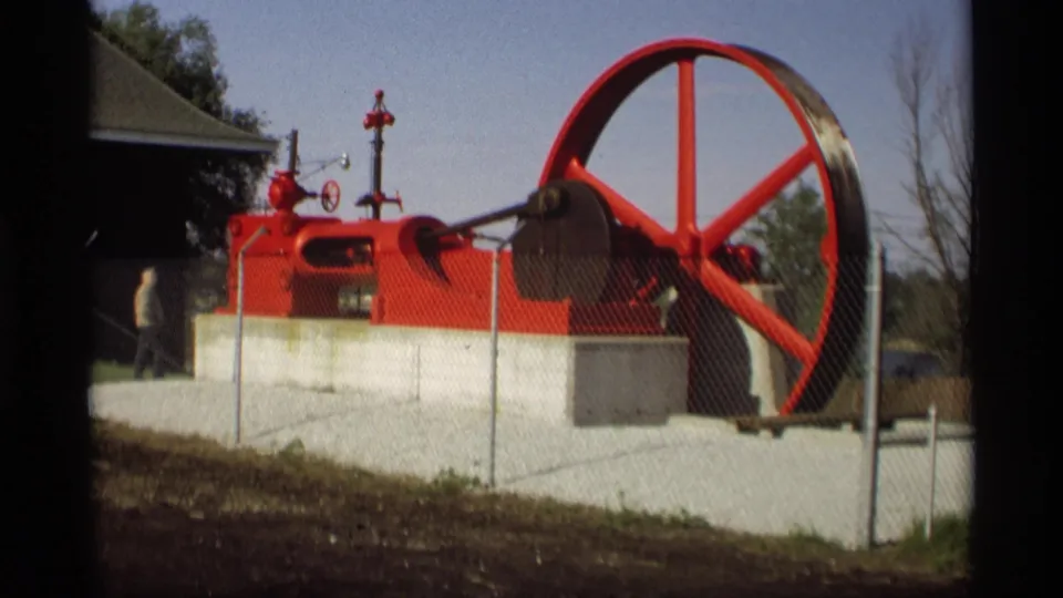 1969 Holland, Michigan frame showing the red machine display as a distant person walks past near the left side.