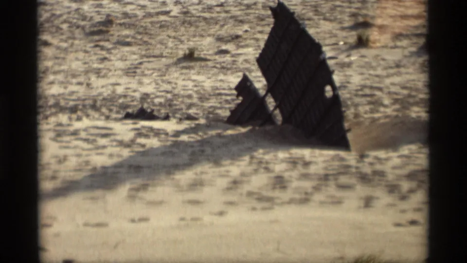 A closer 8mm view shows the weathered wooden beach structure partly embedded in sand at Holland, Michigan in 1969.