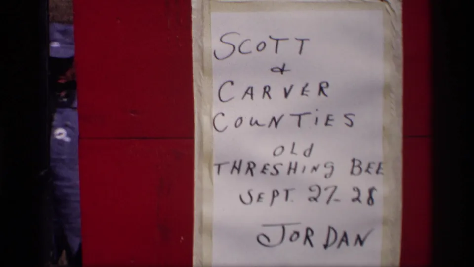 1969 Jordan, Minnesota event sign reading Scott and Carver Counties Old Threshing Bee, taped against a red surface.