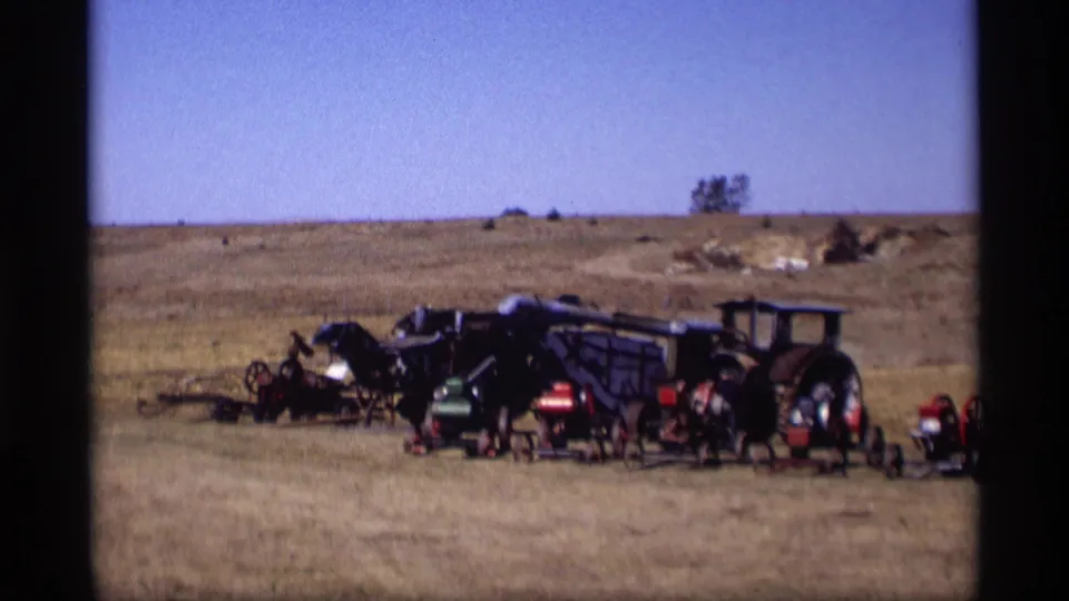 1969 Jordan, Minnesota home-movie view of vintage tractors and equipment grouped in a dry rural landscape.
