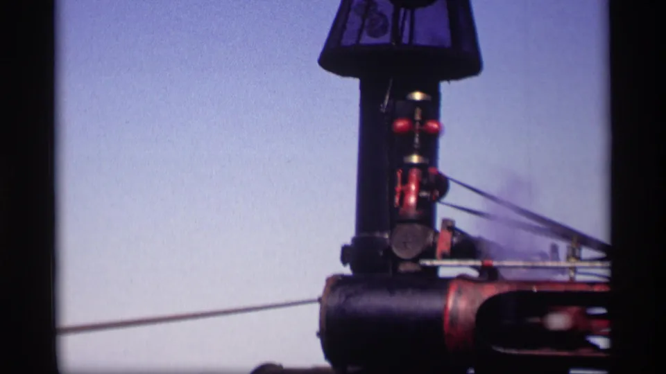 The tractor's tall smokestack and upper boiler details appear against the sky in the 1969 Minnesota home-movie footage.