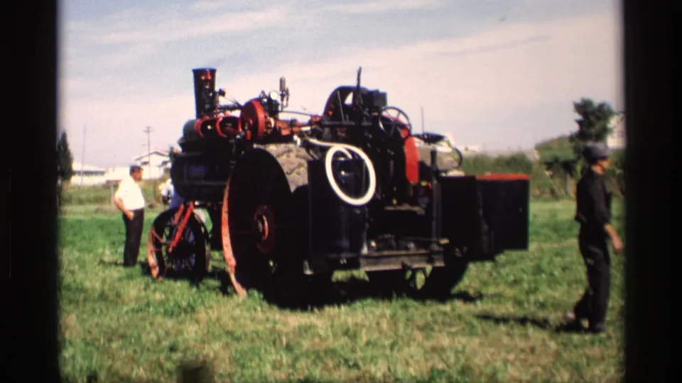 The steam tractor remains centered in the grassy exhibition area, with men standing nearby during the 1969 Mabel, Minnesota demonstration.