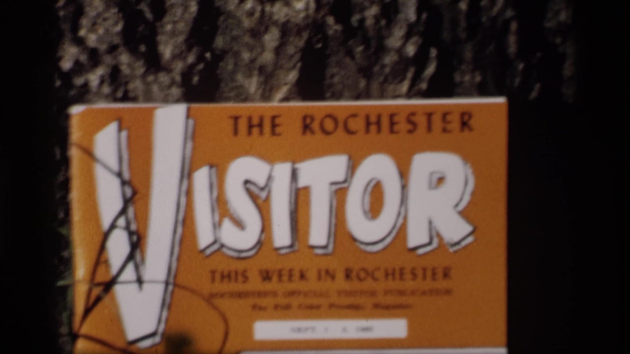 A similar 1969 home-movie view of The Rochester Visitor cover, with the title and graphic cover art visible.