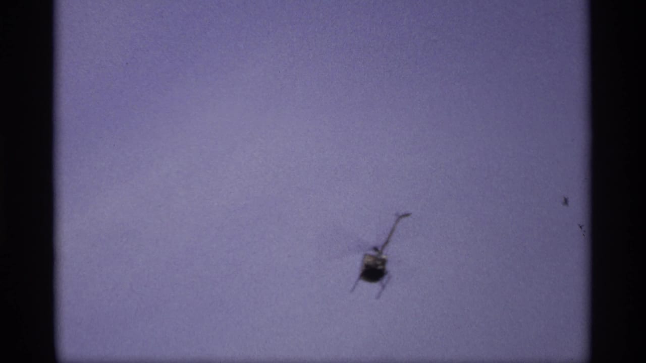 1969 Saint Paul 8mm frame with a helicopter above the flood scene and roadway signs partly visible below.