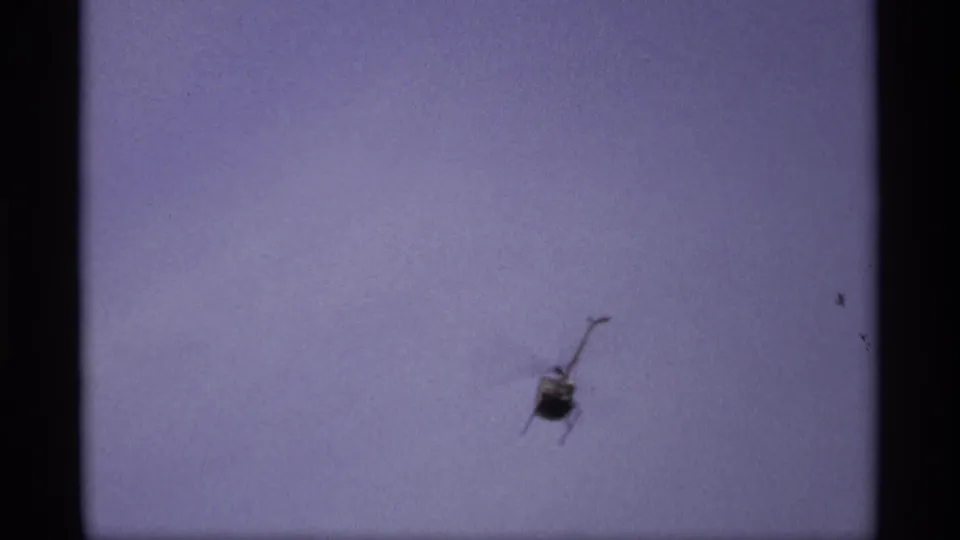 1969 Saint Paul 8mm frame with a helicopter above the flood scene and roadway signs partly visible below.