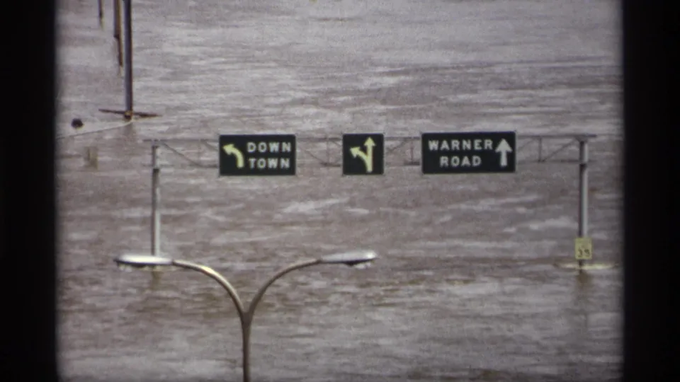 1969 Saint Paul flood footage showing overhead road signs above high water near downtown and Warner Road.