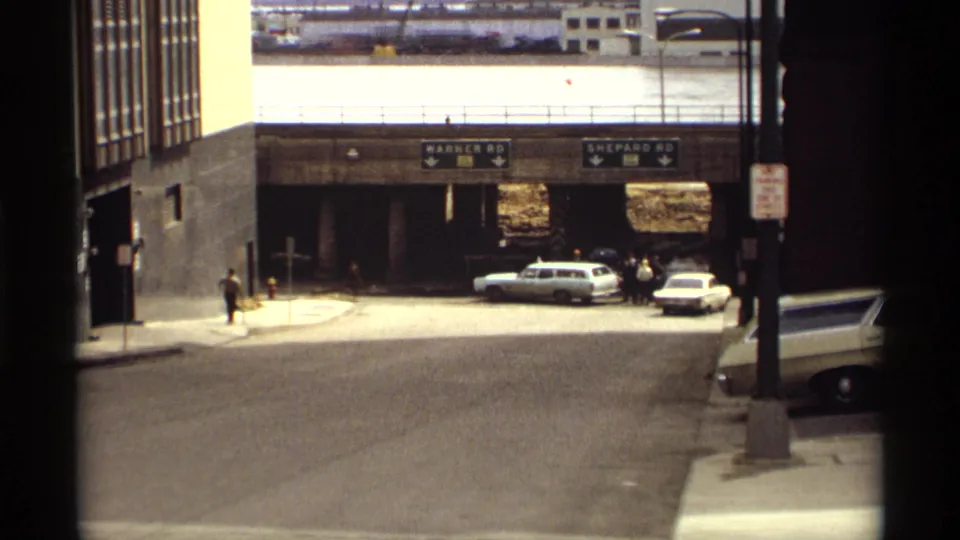 Saint Paul street view shows vintage cars near an underpass signed Warner Rd and Shepard Rd, with floodwater visible beyond.