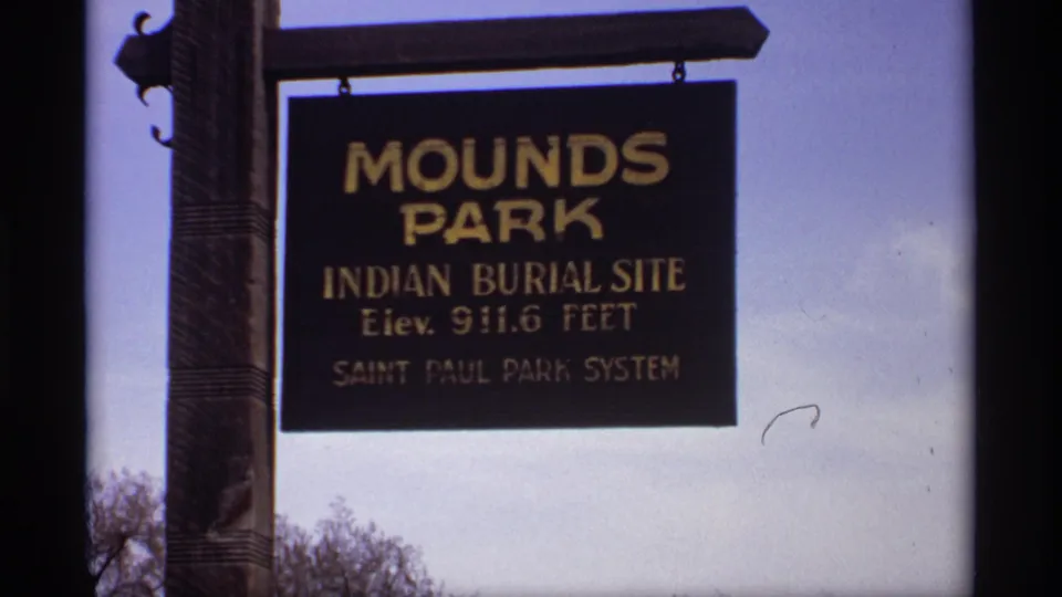 Mounds Park sign in Saint Paul Park System, identifying an Indian Burial Site, filmed from below.