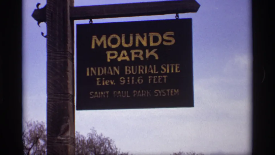 1969 Saint Paul frame of the Mounds Park sign with Indian Burial Site and park-system text visible.