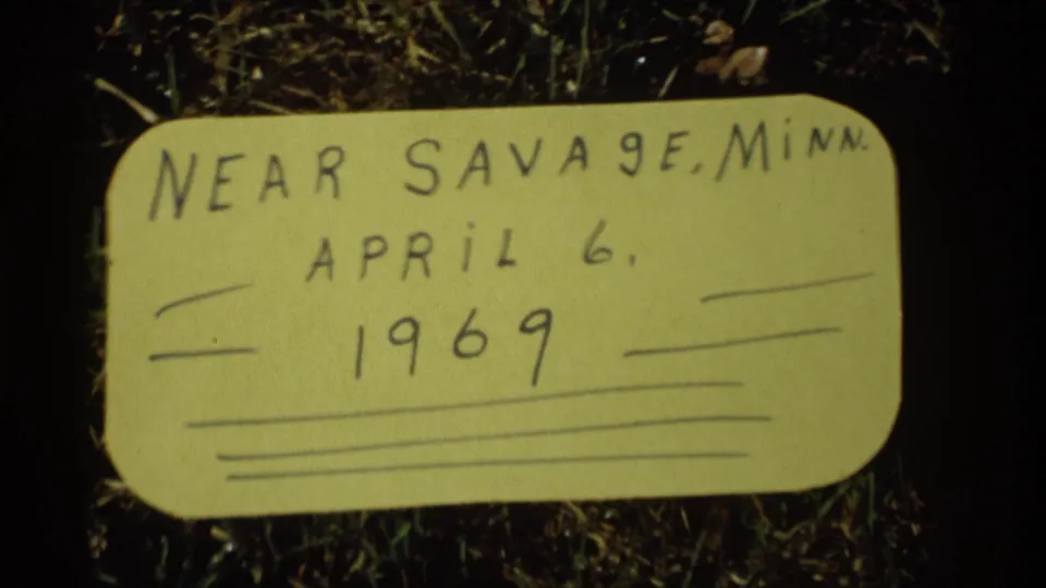 Similar close view of the handwritten 1969 Savage, Minnesota label, softly focused on grass.