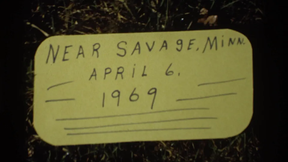 Close home-movie frame of the paper label reading near Savage, Minnesota, April 6, 1969, with ruled lines below.